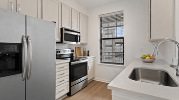 Granite or quartz countertops in kitchen and bath